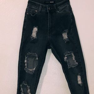 Ripped medium washed Fashion Nova jeans.